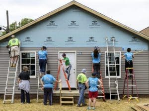 Volunteers painting a new house