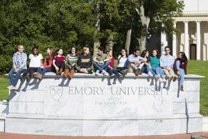 Admitted Emory students sitting in the signage