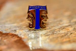 Thespian Society pin in a table