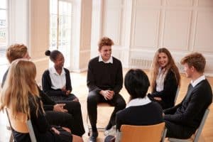 students in a circle doing a club activity