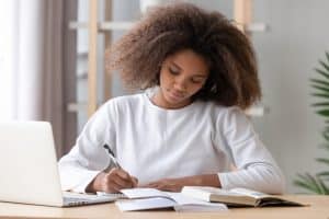 Female student writing on her notebook