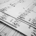 a pile of music sheets that students who compete on the American Protégé see every practice.