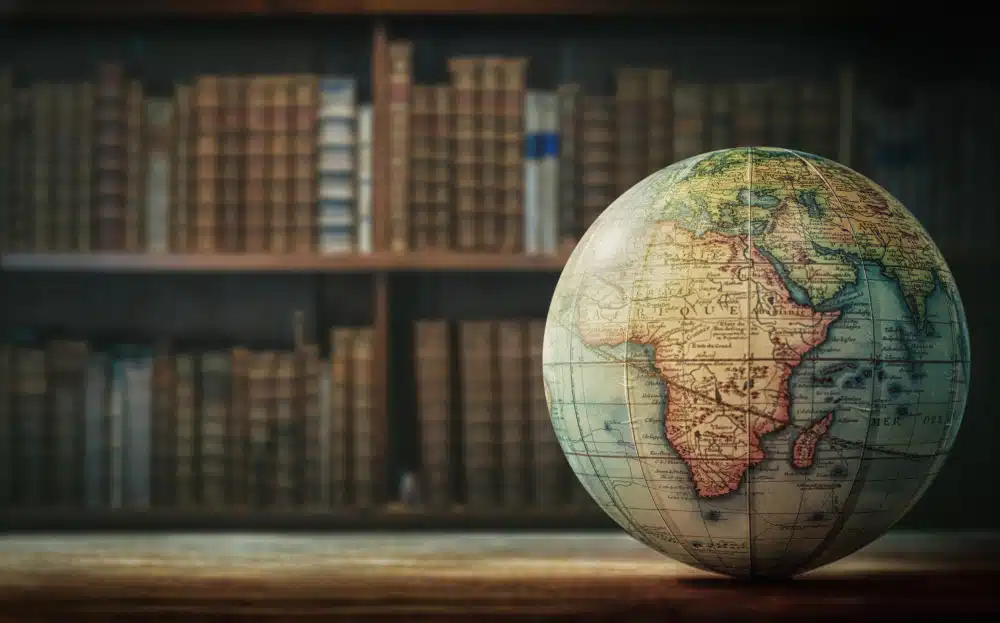 a globe in front of a bookshelf