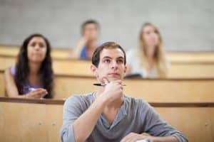 In a classroom, students are listening to the lecture