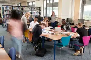 A teacher helping her students in the library