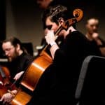 a picture of a boy playing violin linked to all county music festival for students exploring extracurricular interests