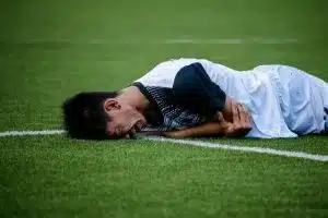 soccer player crying in field, probably injured
