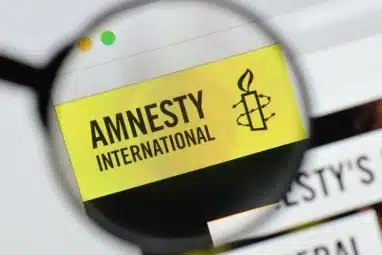 amnesty international logo flashed unto a screen