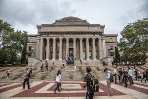 Columbia University's big white building with students walking from every corner