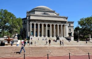 Columbia University's big white building with students walking in front of it