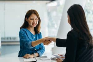 Two women are doing a handshake.