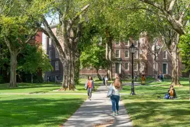 Students walking and resting in front of University Hall.