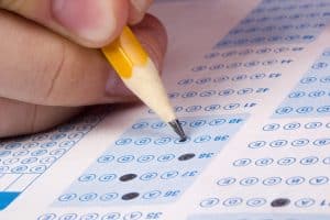 Student filling out answers to a test using a pencil.