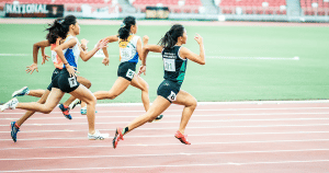 Female students doing a sprint in a running track.