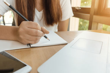 brunette-haired college applicant writing an essay