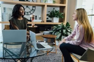 Young female student talking to an interviewer in an office.