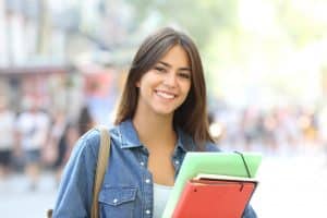 Young female student smiling at the camera.