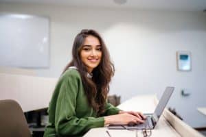 Female student studying using her laptop.