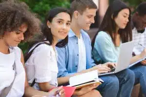 Students huddles in a bench of a campus.