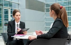 Student talking her interviewer in an office.