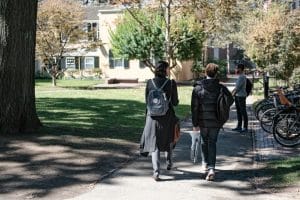 Harvard students walking in the school campus.