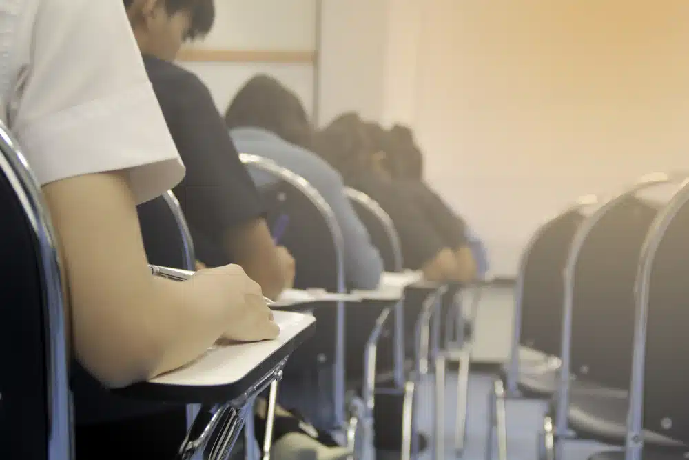 Students taking a SAT exam in a clasroom.