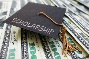 Graduation cap with the word scholarship written on it.