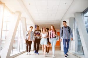 Students walking in the school hallway.