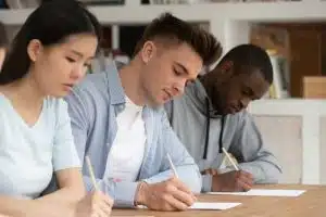 Three students taking an exam in a desktop.