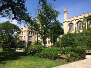 Front building of University of Chicago partially covered by trees