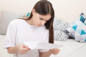Young woman reading a letter.