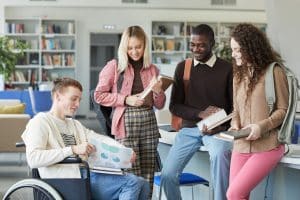 Group of students talking in a classroom.