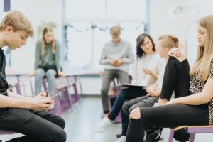 Ivy League students gathered around a room preparing for an activity.