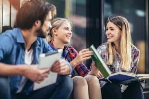 Group of student smiling at each other while talking.