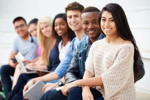 Students sitting in a couch in a room.