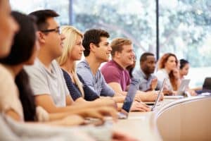 Students listening in front of the class.