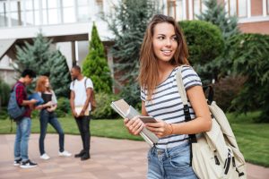 Female student walking near a walkway.