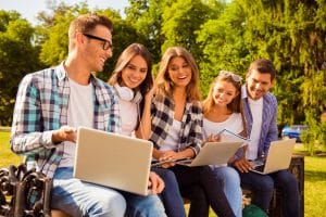 Group of students sitting on the bench while talking.