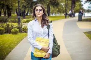 Young woman walking in the school campus.