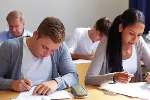 Group of students answering a test in a room.