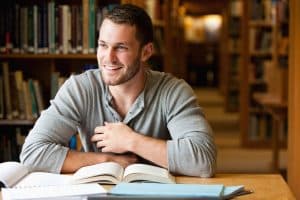 Young male student working on the library.