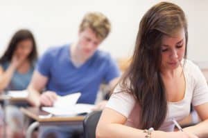 Three students taking the SAT exam.