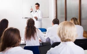 A teacher explaining to the medical students in the classroom.