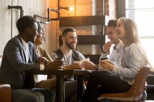 Group of students talking while having a coffee at stanford dining hall