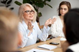 Woman explaining to a group of students.