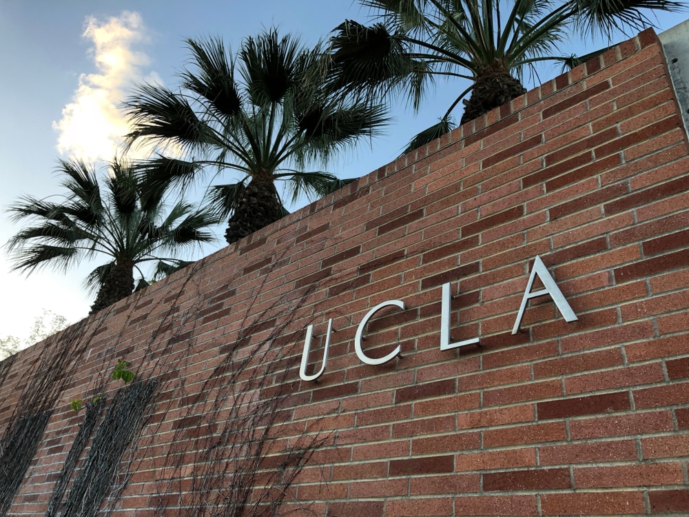 Signage of UCLA placed in a brick wall.