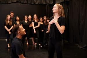 Art students performing in the stage.