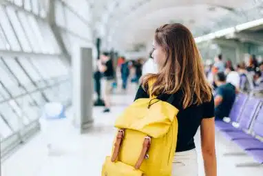 Female student on her back walking in the campus.wa