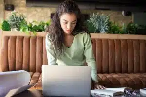 Female student using a laptop for research.