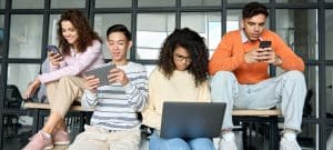 Multiracial students sitting on a bench.